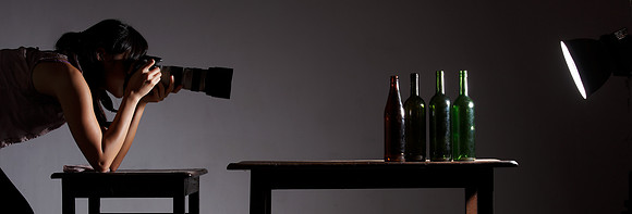 A Japanese student is studing the composition and role of light on a series of bottles.