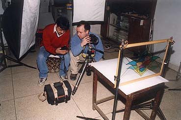 Munish Khanna demonstrates the technique of shooting the glass to one of the students